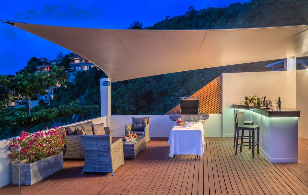 villa solaris poolside bbq and bar area at night