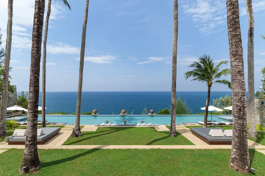 Lawn and palms beside the infinity pool, looking out to sea, Villa Atsadong, Kamala, Phuket