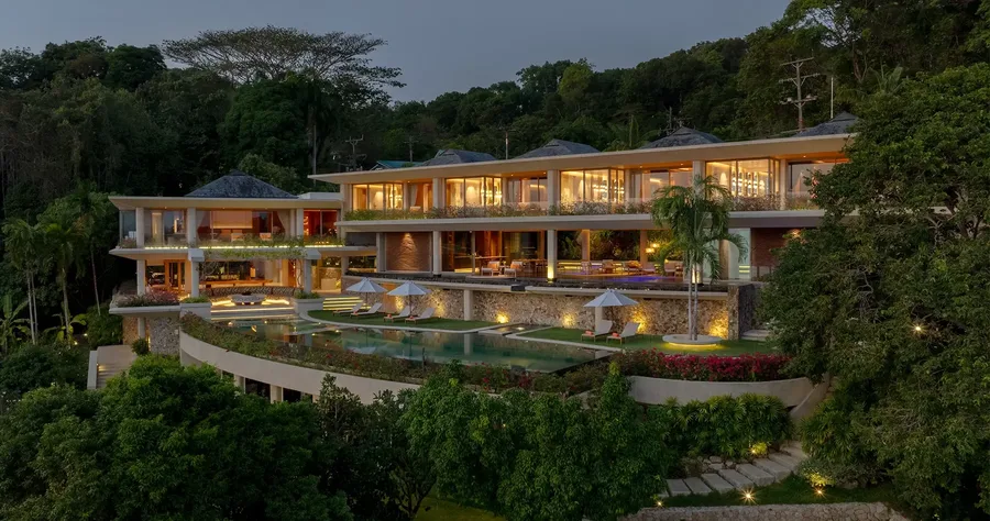Villa Cascade lit at dusk above the infinity pool