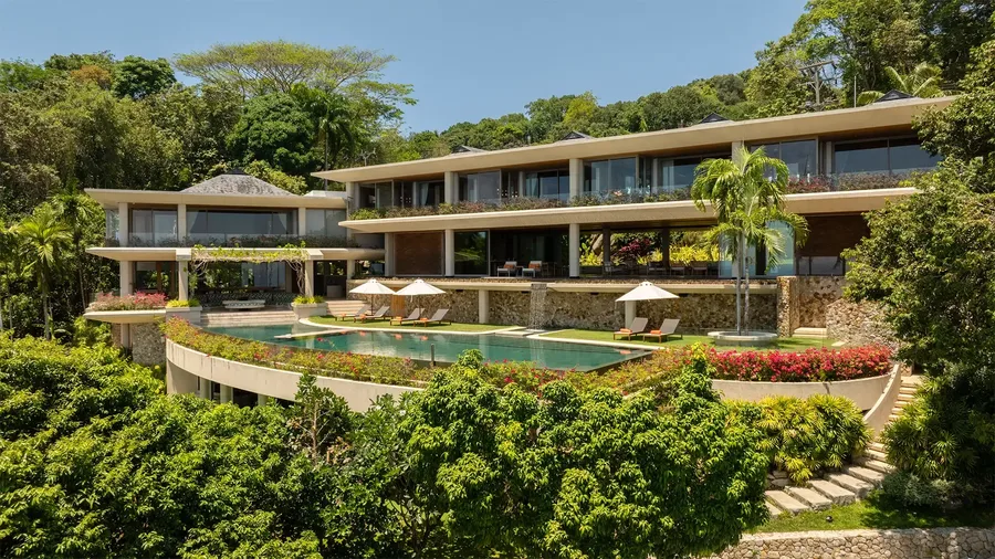 Aerial view of Villa Cascade layered down the hillside above the infinity pool