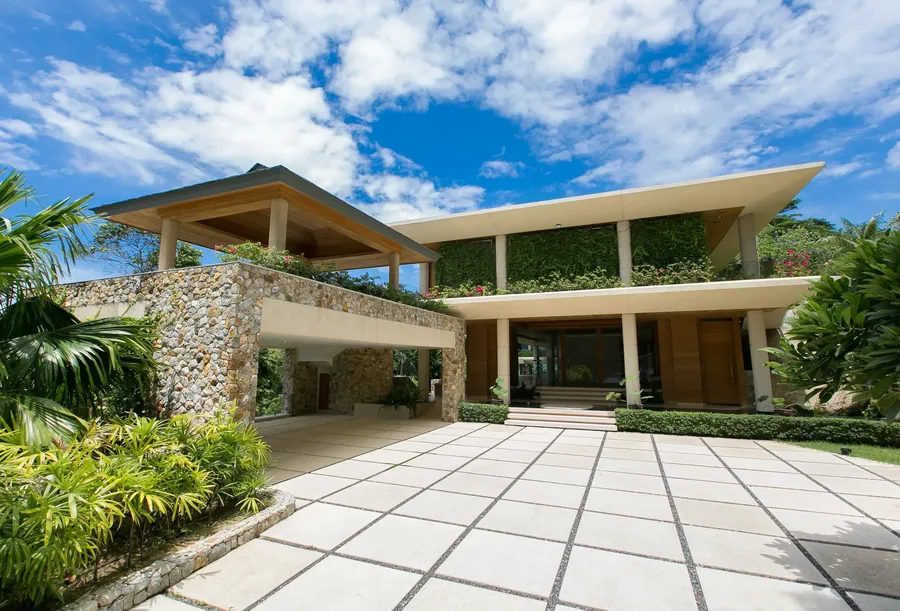 Stone porte-cochere and arrival court at Villa Cascade