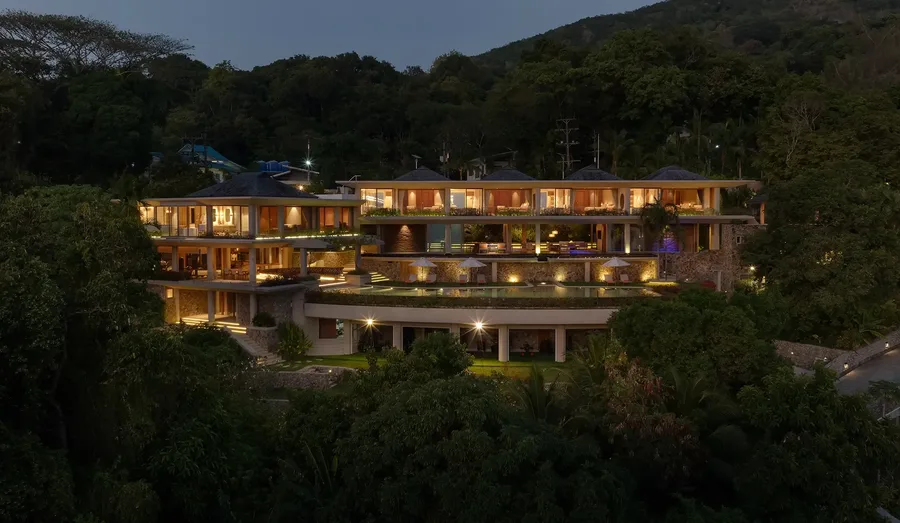 Villa Cascade lit at night on Millionaire’s Mile