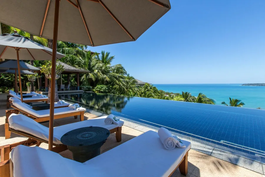Pool loungers with towels and the sea beyond, Villa Daran, Kamala, Phuket